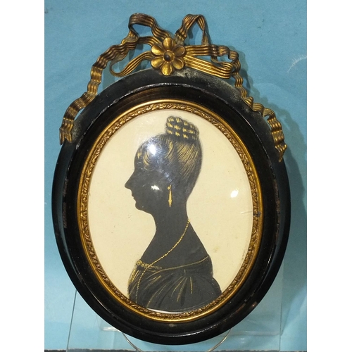 621 - An early-19th century painted silhouette portrait of a lady, circa 1820's, painted in black with bro... 