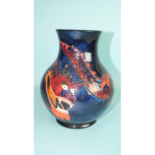 771 - A modern Moorcroft baluster-shaped vase decorated with a dragon on a blue ground, 24.5cm high, facto... 