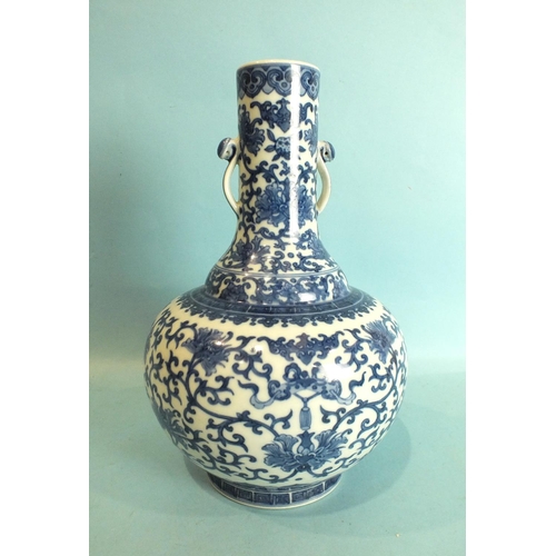 798 - A Chinese bottle shaped vase with blue and white foliate decoration and pierced handles, seal mark b... 