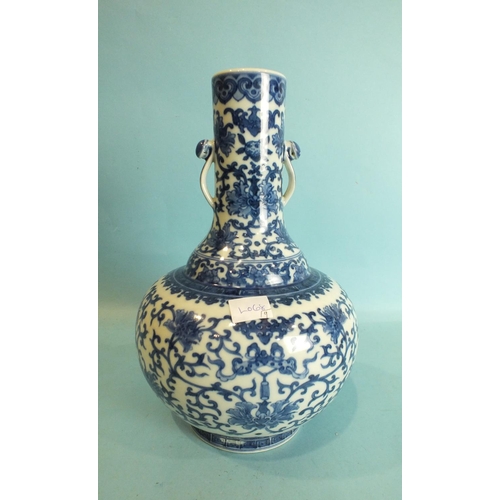 798 - A Chinese bottle shaped vase with blue and white foliate decoration and pierced handles, seal mark b... 