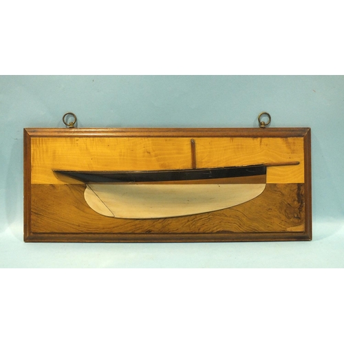 816 - A late-19th century wood half-block model of a yacht, the painted hull with single mast stump and bo... 