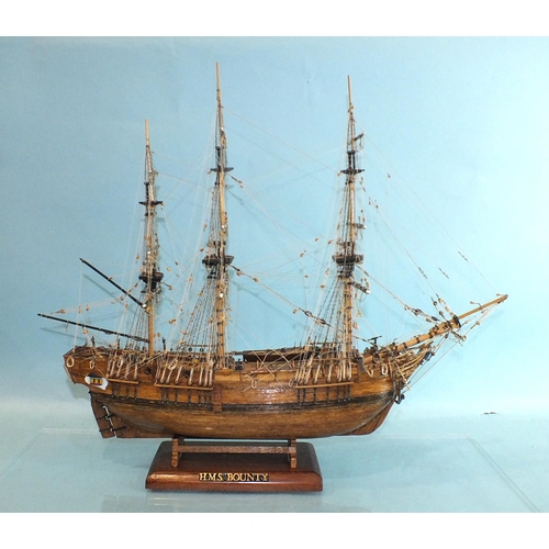 817 - A detailed model of HMS Bounty, with full deck details and rigging, on stand, in Perspex case, 52cm ... 