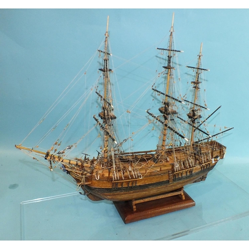 817 - A detailed model of HMS Bounty, with full deck details and rigging, on stand, in Perspex case, 52cm ... 