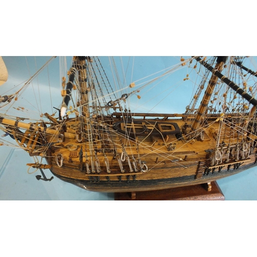 817 - A detailed model of HMS Bounty, with full deck details and rigging, on stand, in Perspex case, 52cm ... 