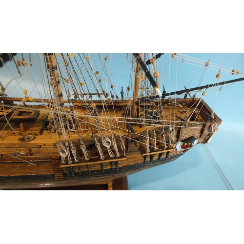 817 - A detailed model of HMS Bounty, with full deck details and rigging, on stand, in Perspex case, 52cm ... 