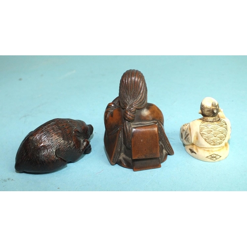 828 - A Japanese boxwood netsuke in the form of a seated man holding a long-nosed mask, with signature to ... 