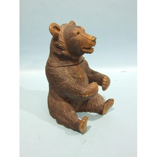 849 - A 19th/20th century carved wood Black Forest tobacco jar and cover in the form of a seated bear, wit... 