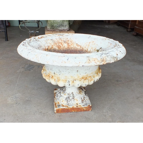 875 - A shallow cast iron campana-shaped garden urn, 49cm diameter, 73cm high.