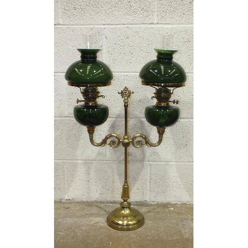 161 - A reproduction student brass double oil lamp with green glass reservoirs and shades, 81cm high overa... 