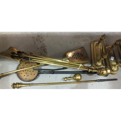 170 - A brass fire kerb with tubular rail, 135cm, two pairs of three fire brasses (af), a pair of brass fi... 