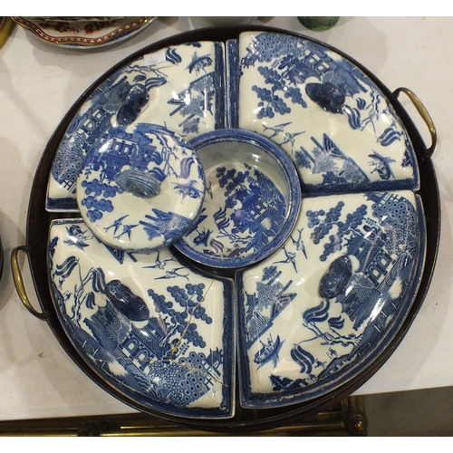 171 - A 19th century blue and white willow pattern supper set, comprising four crescent shaped dishes and ... 