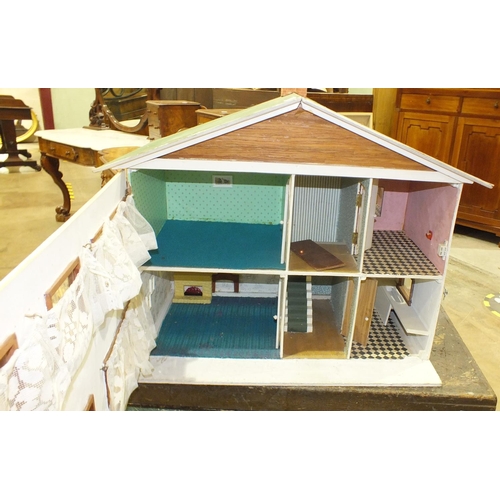 173 - A scratch-built dolls house, 64.5cm wide, 55cm high and a small collection of dolls house furniture.