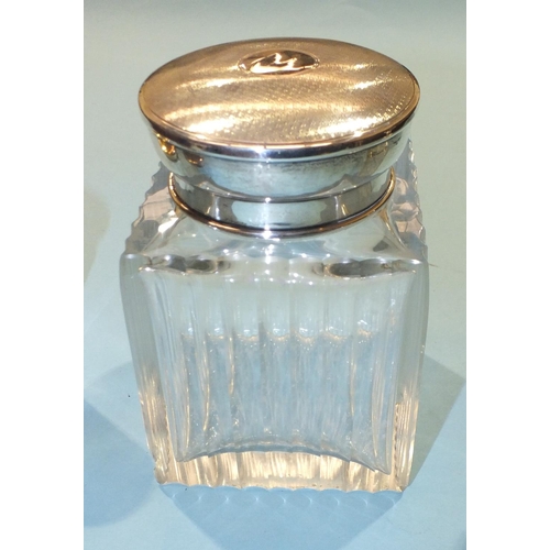 216 - A square glass dressing table bottle of ribbed form with stopper and silver cover, Birmingham 1925, ... 