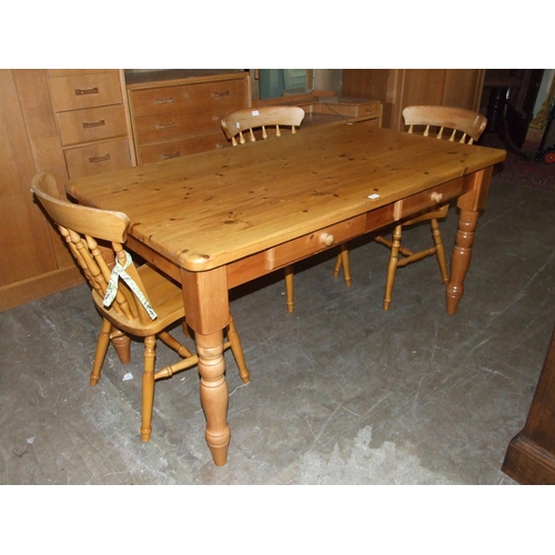 67 - A modern pine kitchen table with two drawers, on turned legs, a pine occasional table in the form of... 