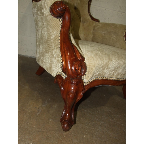 69 - A mahogany button-back salon chair, the carved wood frame with serpentine seat on carved cabriole fr... 