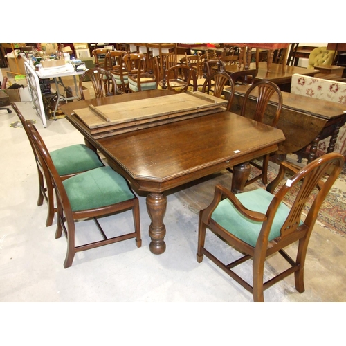 71 - A large early 20th century oak extending dining table, the top with three spare leaves on turned leg... 