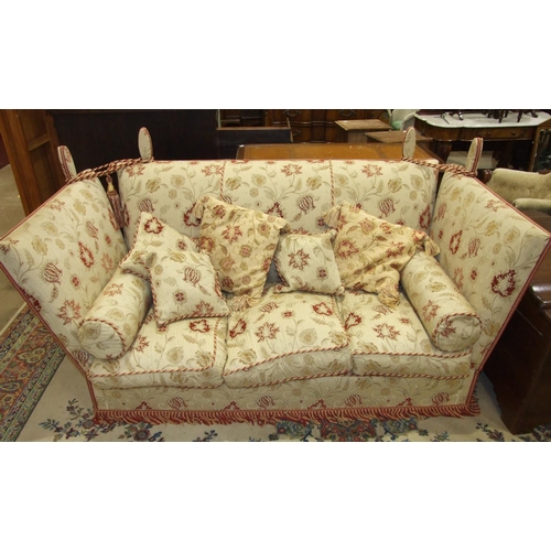 73 - An upholstered three-seater knoll settee, 184cm long.