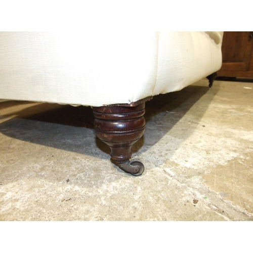 76 - A late 19th century upholstered Chesterfield settee on bun feet, 180cm wide.