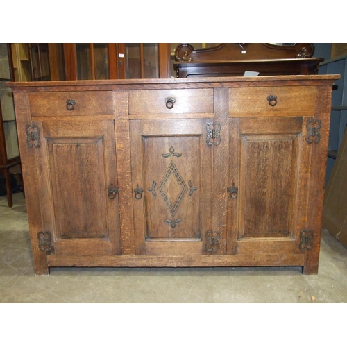 81 - An oak dresser base in the Arts and Crafts taste, having an arrangement of three drawers and three c... 