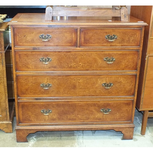 28 - A reproduction burr walnut and cross-banded chest of two short and three long cockbeaded drawers, on... 