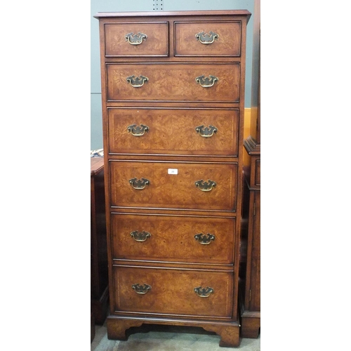 29 - A similar tall chest of two short and five graduated long drawers, 130cm high, 60cm wide.... 