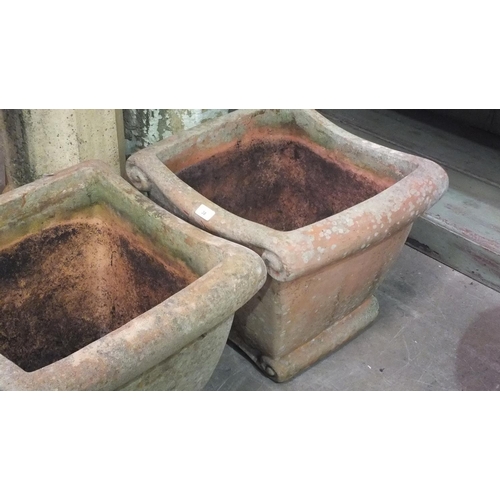 38 - A pair of terracotta-coloured pottery square-form planters, 44cm high, 47cm square, (2).... 