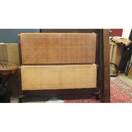 46 - A 4' 6'' mahogany Bergère bed and side rail, with double-caned foot and single-caned head boards, (c... 