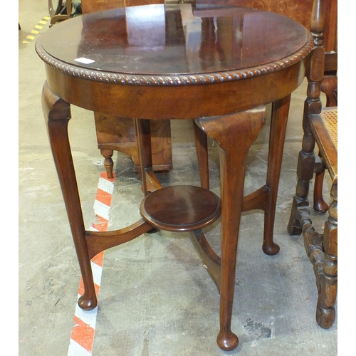 59 - A circular mahogany occasional table on turned legs with pad feet united by an under-tier, 63cm diam... 