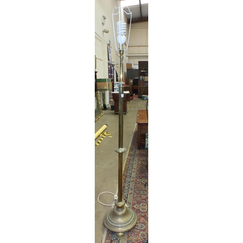 9 - A late-19th/early-20th century brass adjustable lamp standard, on circular base and three feet, (con... 