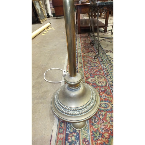9 - A late-19th/early-20th century brass adjustable lamp standard, on circular base and three feet, (con... 