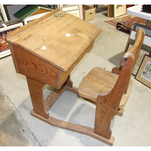 10 - An early 20th century pitch pine and elm school desk and chair, the desk with sloping hinged lid and... 