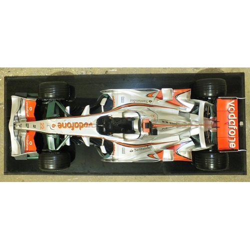 401 - A plastic display model of McLaren Mercedes MP4-22 F1 racing car, 60cm, on plinth with Perspex cover... 