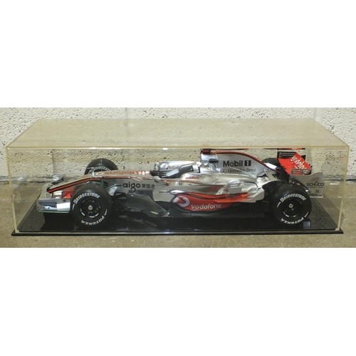 401 - A plastic display model of McLaren Mercedes MP4-22 F1 racing car, 60cm, on plinth with Perspex cover... 