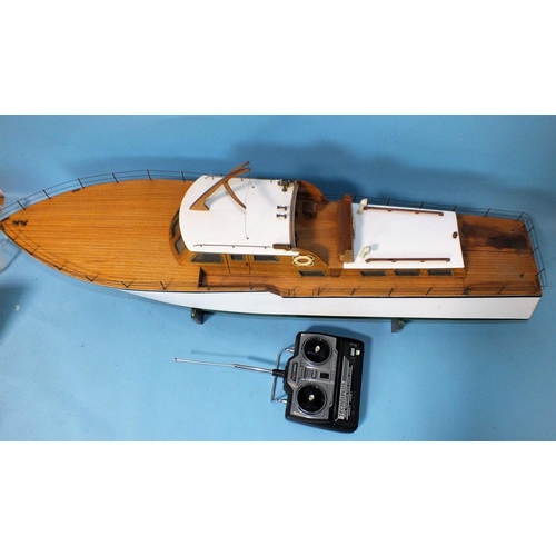 482 - A remote-control model of a motor launch with metal and plastic deck detail, 111cm long, on stand wi... 