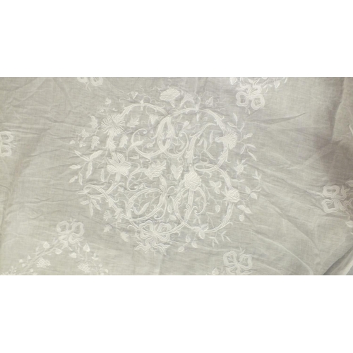 505 - A large fine lawn table cloth profusely embroidered with central scrolling monogram, LB, bows, flowe... 