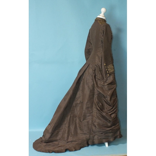 507 - A late-Victorian c1880's brown silk dress, the front buttoned (37 buttons) from ruched neckline to h... 