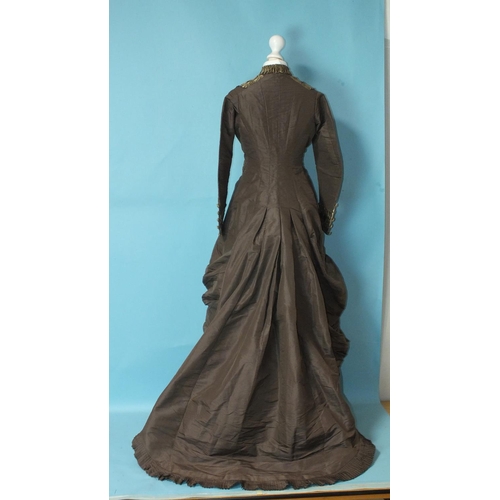 507 - A late-Victorian c1880's brown silk dress, the front buttoned (37 buttons) from ruched neckline to h... 