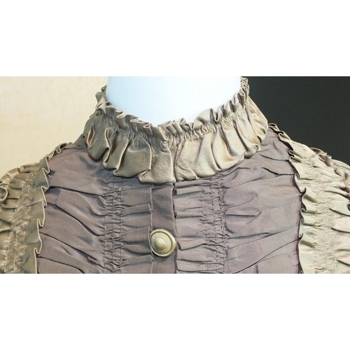 507 - A late-Victorian c1880's brown silk dress, the front buttoned (37 buttons) from ruched neckline to h... 