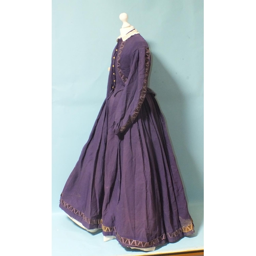 508 - An early-Victorian three-piece dress, hand-stitched, of purple wool, the boned bodice with brass but... 