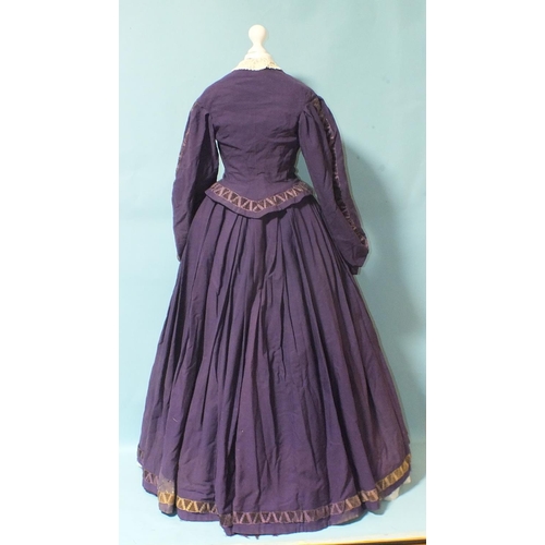 508 - An early-Victorian three-piece dress, hand-stitched, of purple wool, the boned bodice with brass but... 