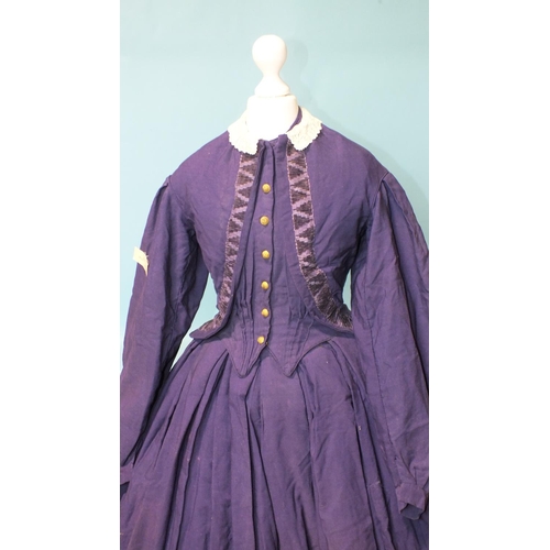 508 - An early-Victorian three-piece dress, hand-stitched, of purple wool, the boned bodice with brass but... 