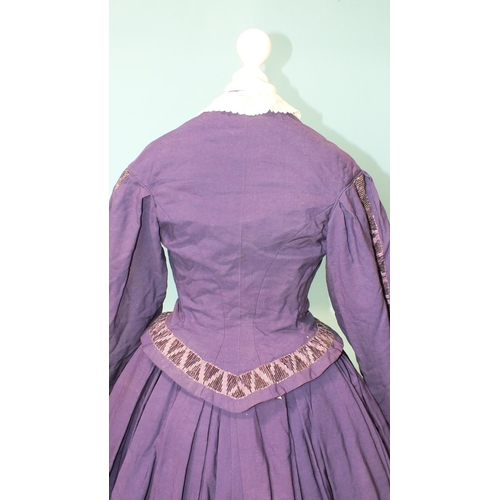 508 - An early-Victorian three-piece dress, hand-stitched, of purple wool, the boned bodice with brass but... 