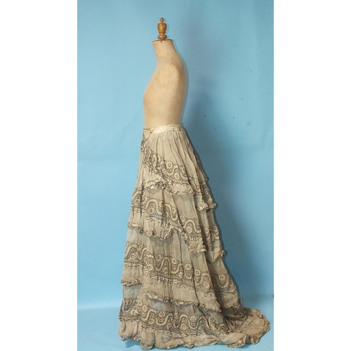 512 - A Victorian hand-stitched brown silk skirt, decorated with two flounces and taupe silk panels, a hea... 