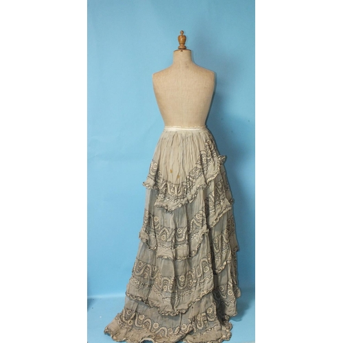 512 - A Victorian hand-stitched brown silk skirt, decorated with two flounces and taupe silk panels, a hea... 