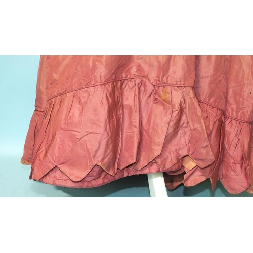 524 - An early-19th century puce silk dress, hand-stitched, the bodice gathered at the front and on the sh... 