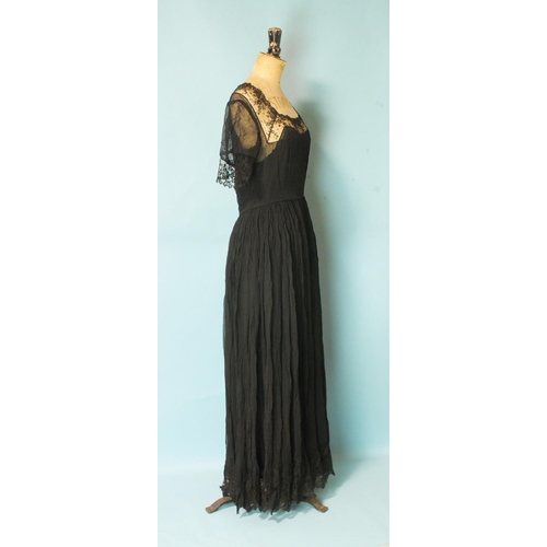 525 - A vintage black silk chiffon and lace evening dress with silk slip, size UK12 approximately, a black... 