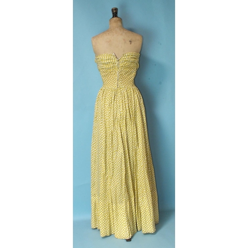 526 - A vintage polka dot yellow and white cotton full-length strapless dress with ruched and boned bodice... 