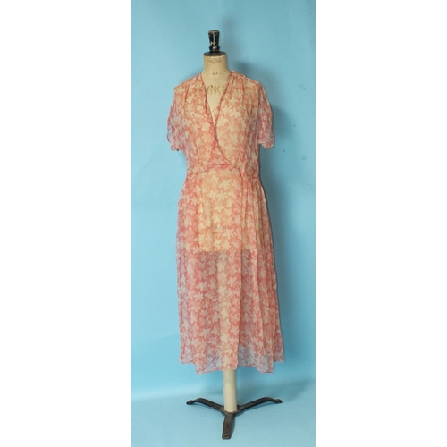 527 - Victor Joselyn, a 1950's sun dress with fitted bodice and full skirt, size '36', a coral chiffon dre... 