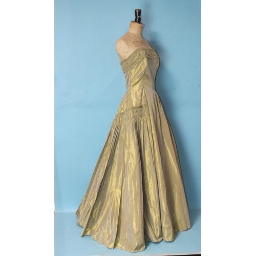 529 - Ricci Michaels, a 1950's lemon/old gold taffeta evening gown, the strapless boned bodice with ruched... 