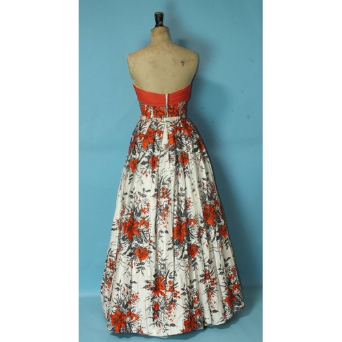 531 - Frank Usher, a 1950's floral cotton sateen evening dress with fitted boned bodice with red chiffon b... 